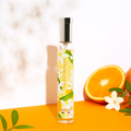 Adopt Fleur D'oranger Ensoleillee fragrance bottle with a silver cap, featuring a vibrant floral label,
