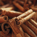 Adopt Fleur De Gingembre close-up showing the texture of cinnamon sticks, highlighting their natural curves and rough surface