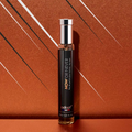 Adopt Fleur De Gingembre perfume in a sleek black and silver bottle,