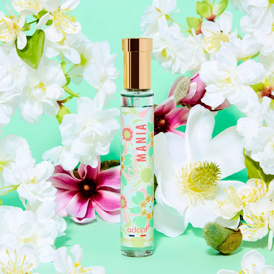 Adopt Flower Mania perfume bottle with a gold cap and floral design,