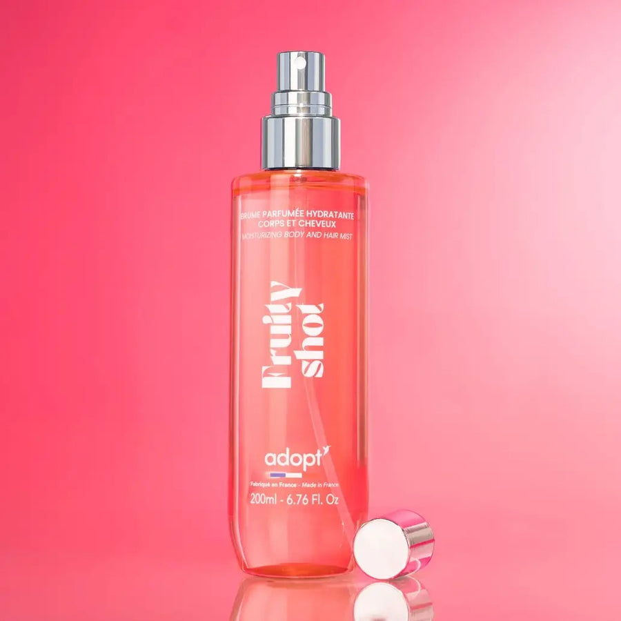 Adopt Fruit Shot Body & Hair Mist in a clear bottle with a silver spray top,