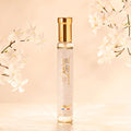 Adopt L'Or Blanc Eau de Parfum with glitter, a tall slender bottle with a gold cap, surrounded by white jasmine flowers