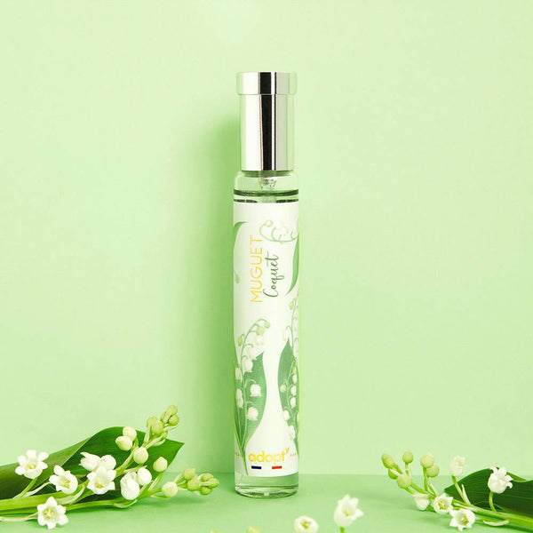 Adopt Muguet Coquet perfume bottle with a silver cap and lily of the valley design,
