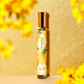 Adopt Osmanthus Eternel Eau de Parfum in a clear bottle with a gold cap, featuring a yellow floral design,