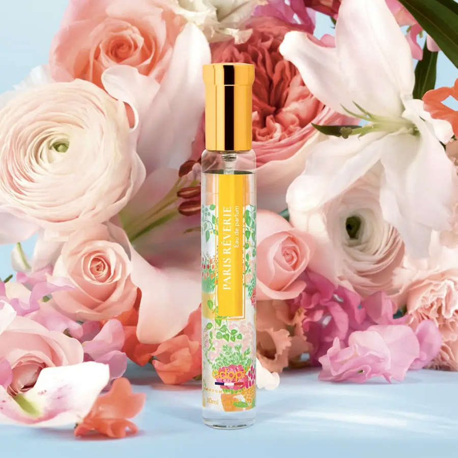 Adopt Paris Rêverie Eau de Parfum bottle with a gold cap and a vibrant floral label,