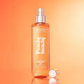 Adopt Peachy Beachy Body & Hair Mist in a clear bottle with a silver spray top and a rose gold cap next to it,