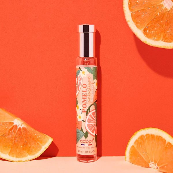 Adopt Pomelo Fantastique perfume bottle with a vibrant label featuring pomelos and flowers,