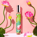 Adopt Rose Diamant perfume bottle with a vibrant green label featuring lotus flowers,