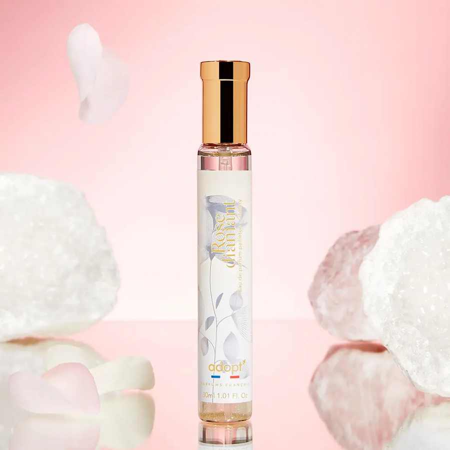 Adopt Rose Diamant eau de parfum with a golden cap and a white label featuring floral designs,