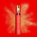 Adopt Starnight Eau de Parfum Pailletee Glittery, a shimmering fragrance in a red bottle with a gold cap,