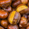 Adopt Sublimissime roasted chestnuts with a glossy finish, some cracked open to reveal the yellow interior