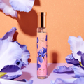 Adopt Tendre Iris perfume bottle with a pink label and purple iris flowers,