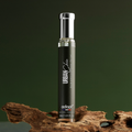 Adopt Urban Chic perfume bottle with a black label and silver cap, standing on a piece of natural wood