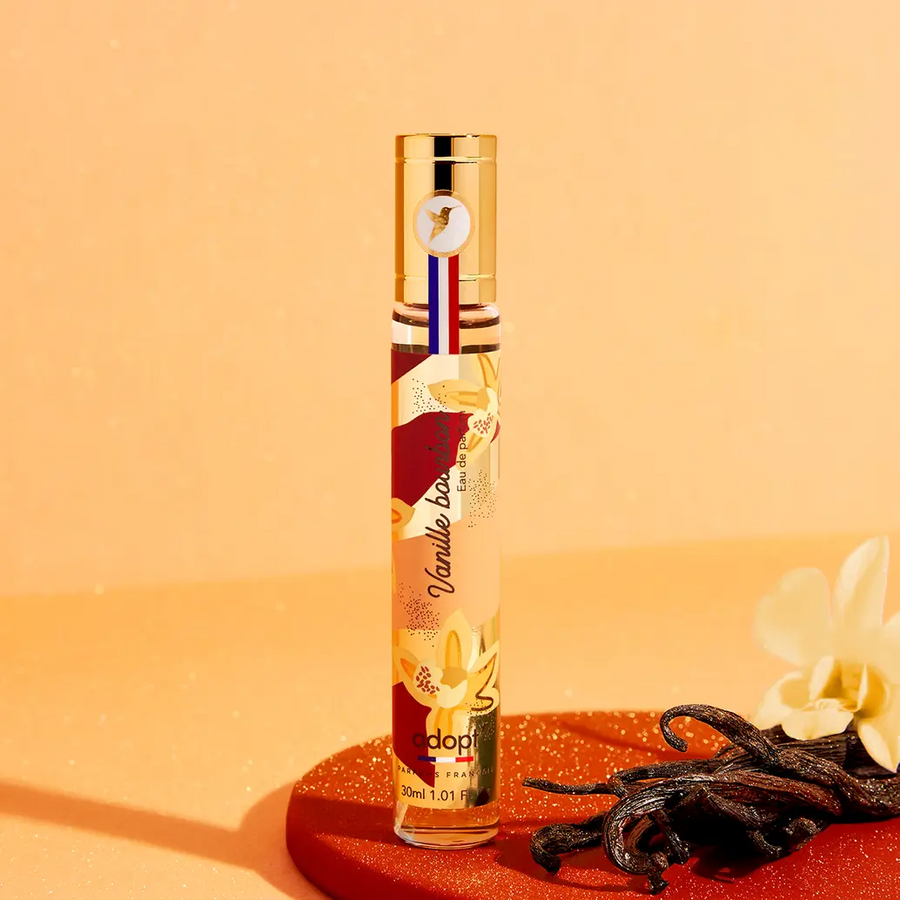 Adopt Vanilla Bourbon perfume bottle with a gold cap and colorful label,