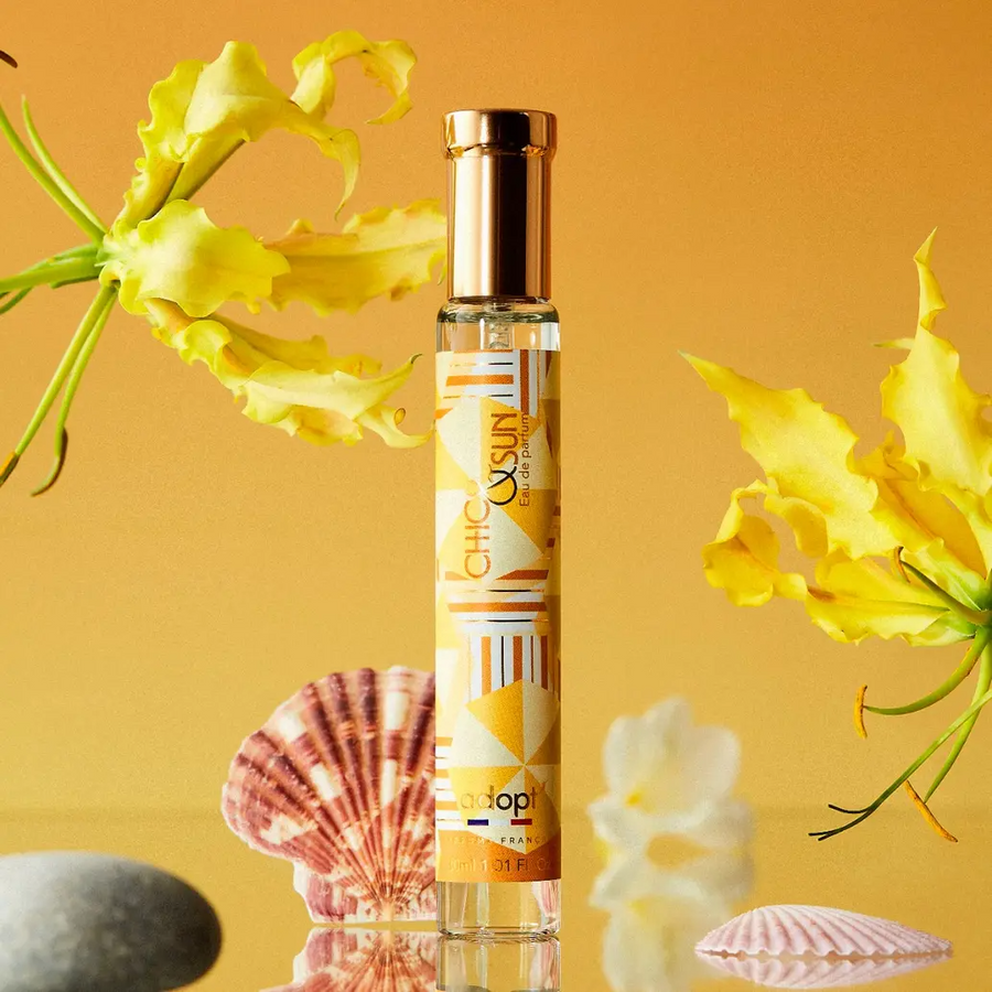 GD11 Repair Ampoule Program with a golden cap and yellow label, surrounded by yellow flowers and seashells