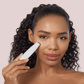 GESKE MicroCurrent Face-Lift Pen 6 in 1 used by a woman to treat the skin around her eye