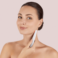 GESKE Skin Firming Wand 7 in 1 held by a woman, gently massaging her neck and jawline