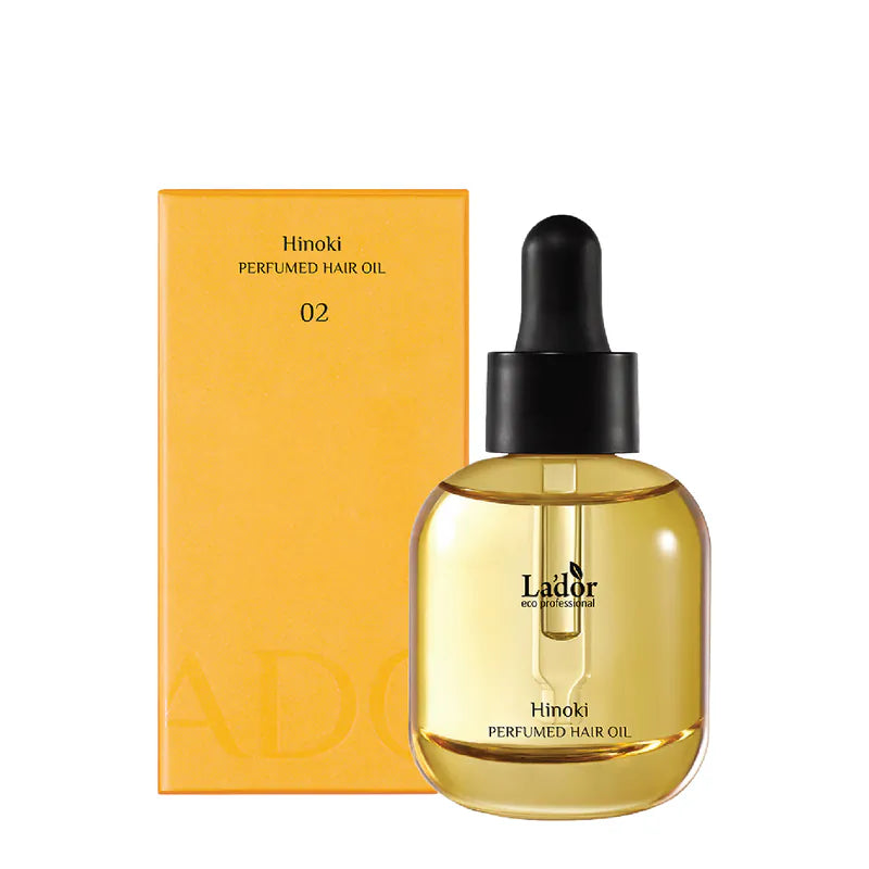 Lador Perfumed Hair Oil Hinoki 30ml in a clear bottle with a dropper, next to its yellow packaging on a white background
