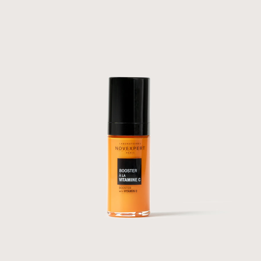 Novexpert Booster Serum with Vitamin C in an orange bottle with a black cap, front view on a white background