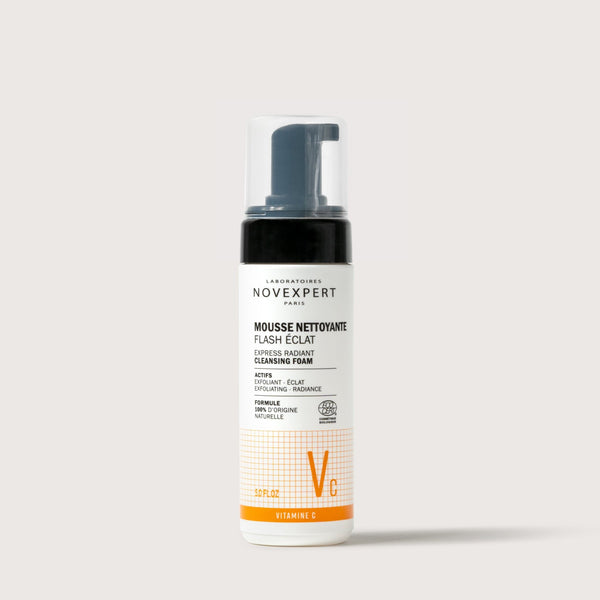 Novexpert Express Radiant Cleansing Foam in a white bottle with an orange grid pattern, front view on a white background