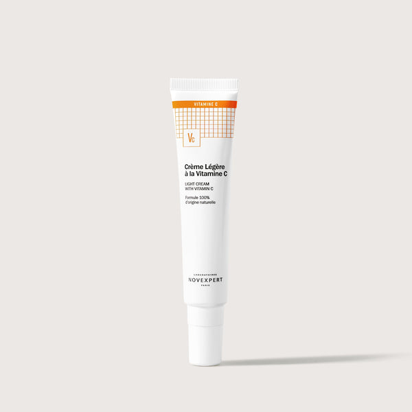 Novexpert Light Cream with Vitamin C in a white tube with an orange top on a white background