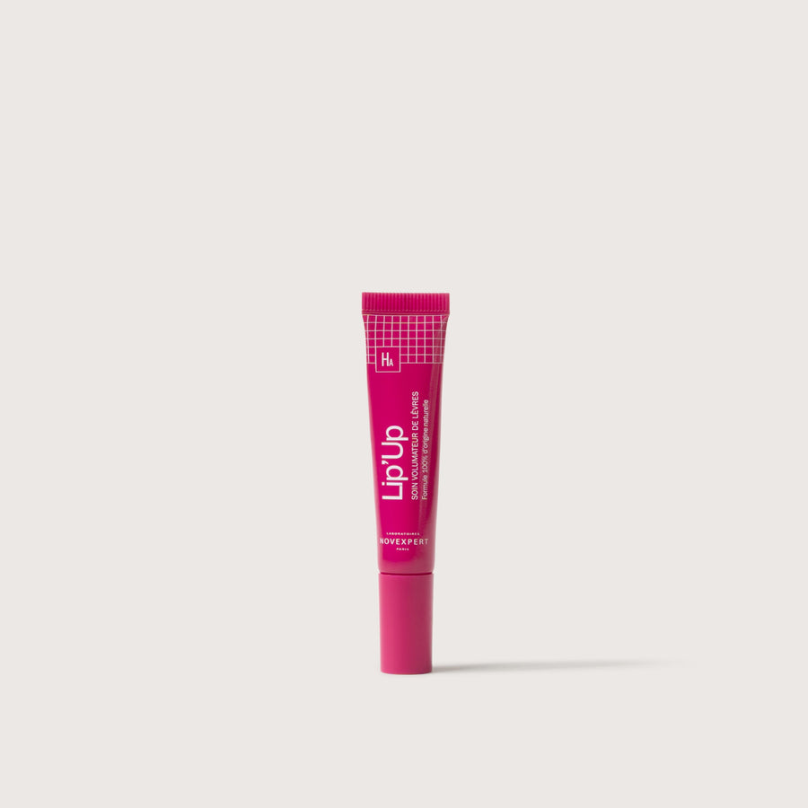 Novexpert Lip' Up lip care product in a pink tube, shown front on a white background