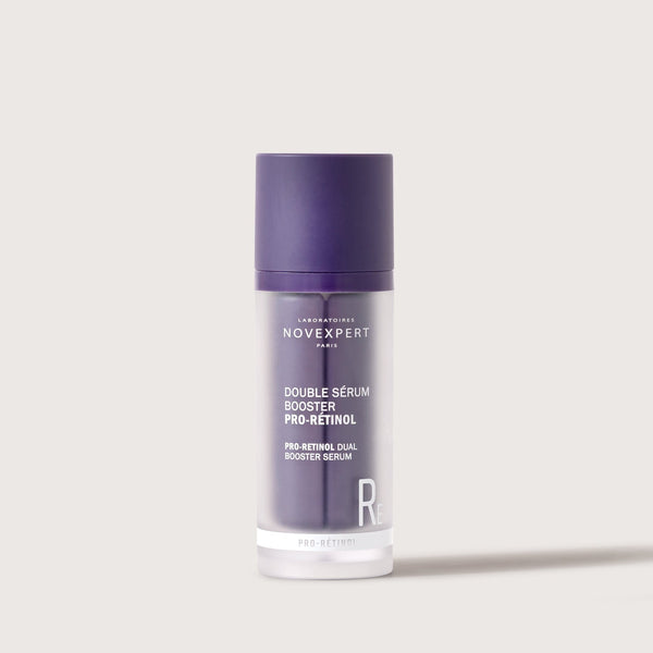 Novexpert Pro-Retinol Dual Booster Serum in a purple and frosted bottle, front view on a white background