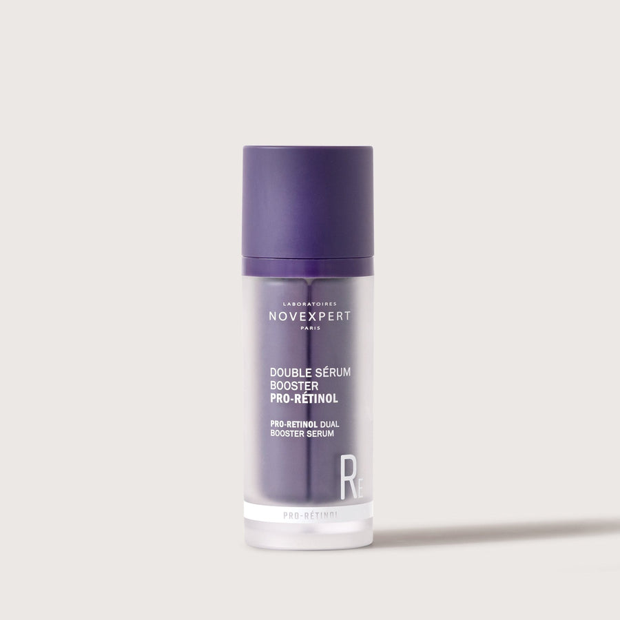 Novexpert Pro-Retinol Dual Booster Serum in a purple and frosted bottle, front view on a white background