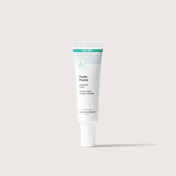 Novexpert Purifying Fluid in a white tube with a green label, featuring the text "Trio-Zinc" and "Zn"