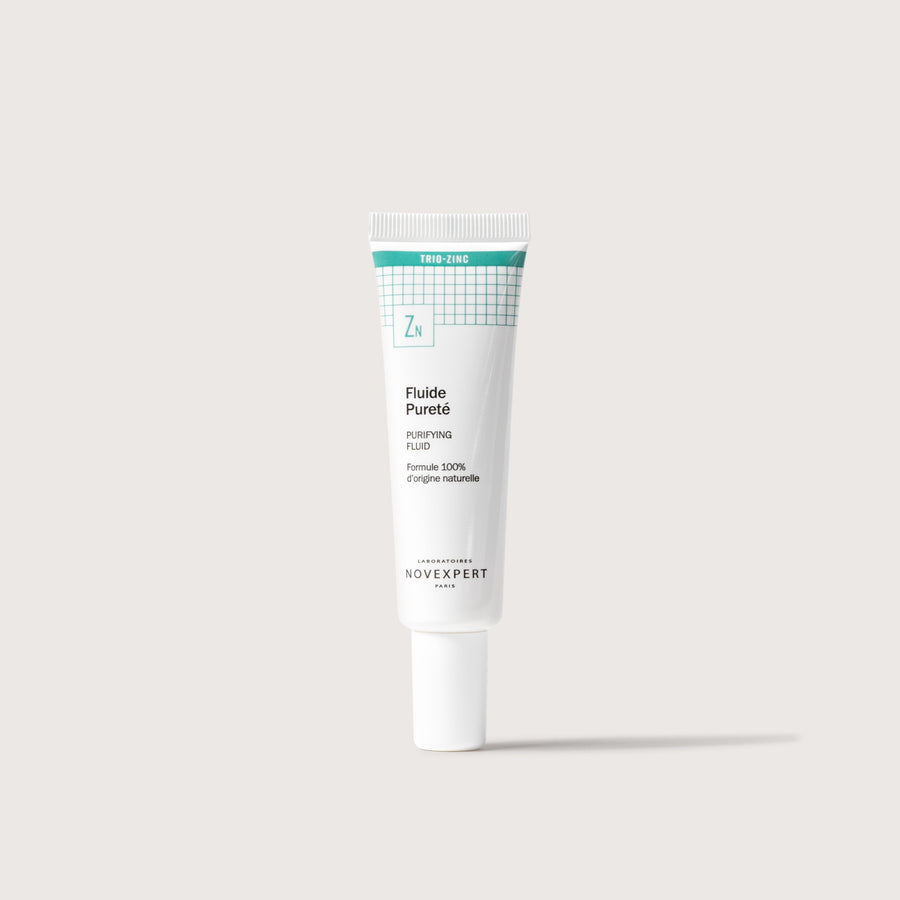 Novexpert Purifying Fluid in a white tube with a green label, featuring the text "Trio-Zinc" and "Zn"