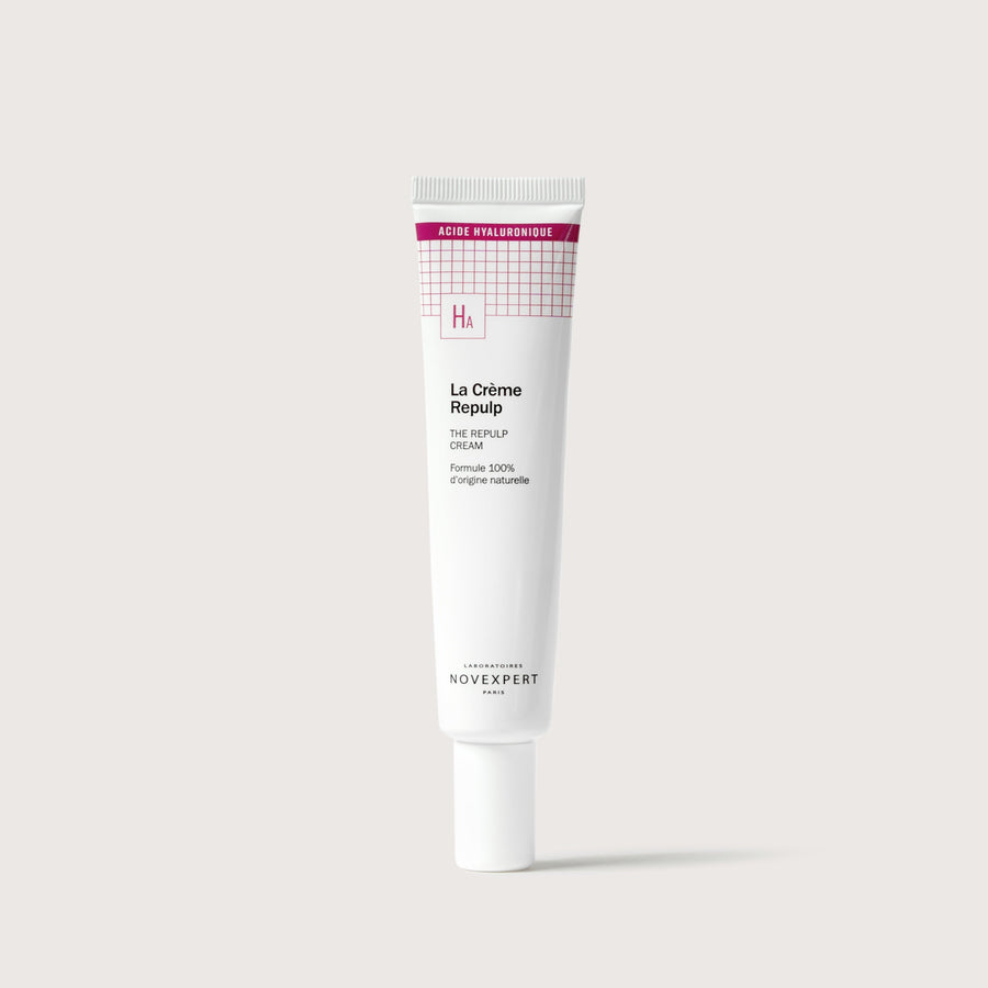 Novexpert The Repulp Cream in a white tube with a pink grid pattern and 'HA' logo, front view on a white background