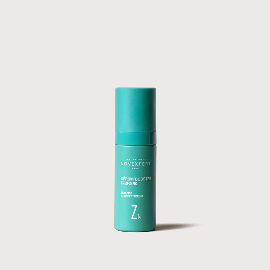 Novexpert Trio Zinc Booster serum in a teal bottle with a white label, front view on a white background