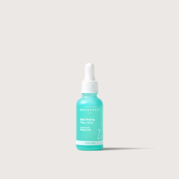 Novexpert Trio Zinc clear skin peeling care in a turquoise bottle with a white dropper on a white background