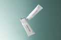 Pestlo Rejurecipe MTS Roller Serum, two white tubes with silver roller applicators, angled against a teal background