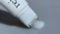 Pestlo Rejurecipe MTS Roller Serum dispensing a white, creamy texture onto a grey surface,