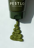 Pestlo Spicule Reborn Peeling Mask squeezed out of the tube, showing its green, textured consistency on a white background